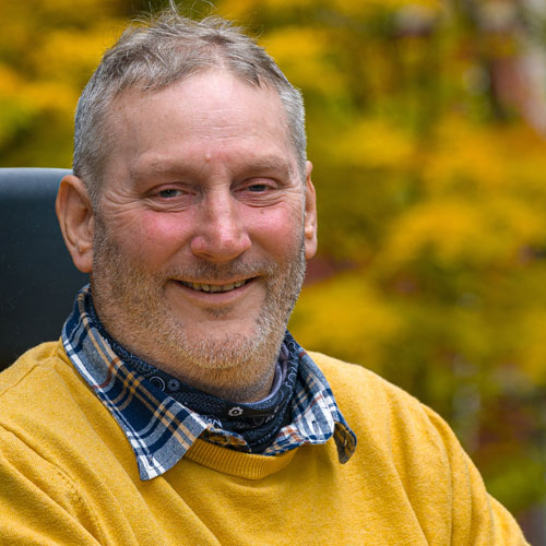 portrait photo of Steven Webb in a checked shirt and yellow top