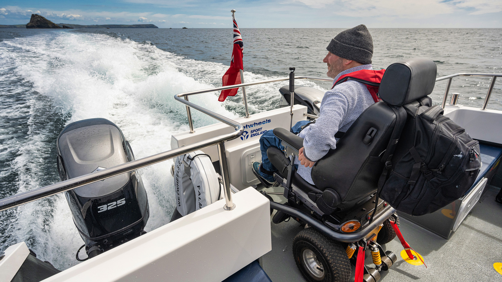 Steven Webb having a mindful moment on WetWheels boat Cornwall looking out over the Falmouth Bay in his electric wheelchair
