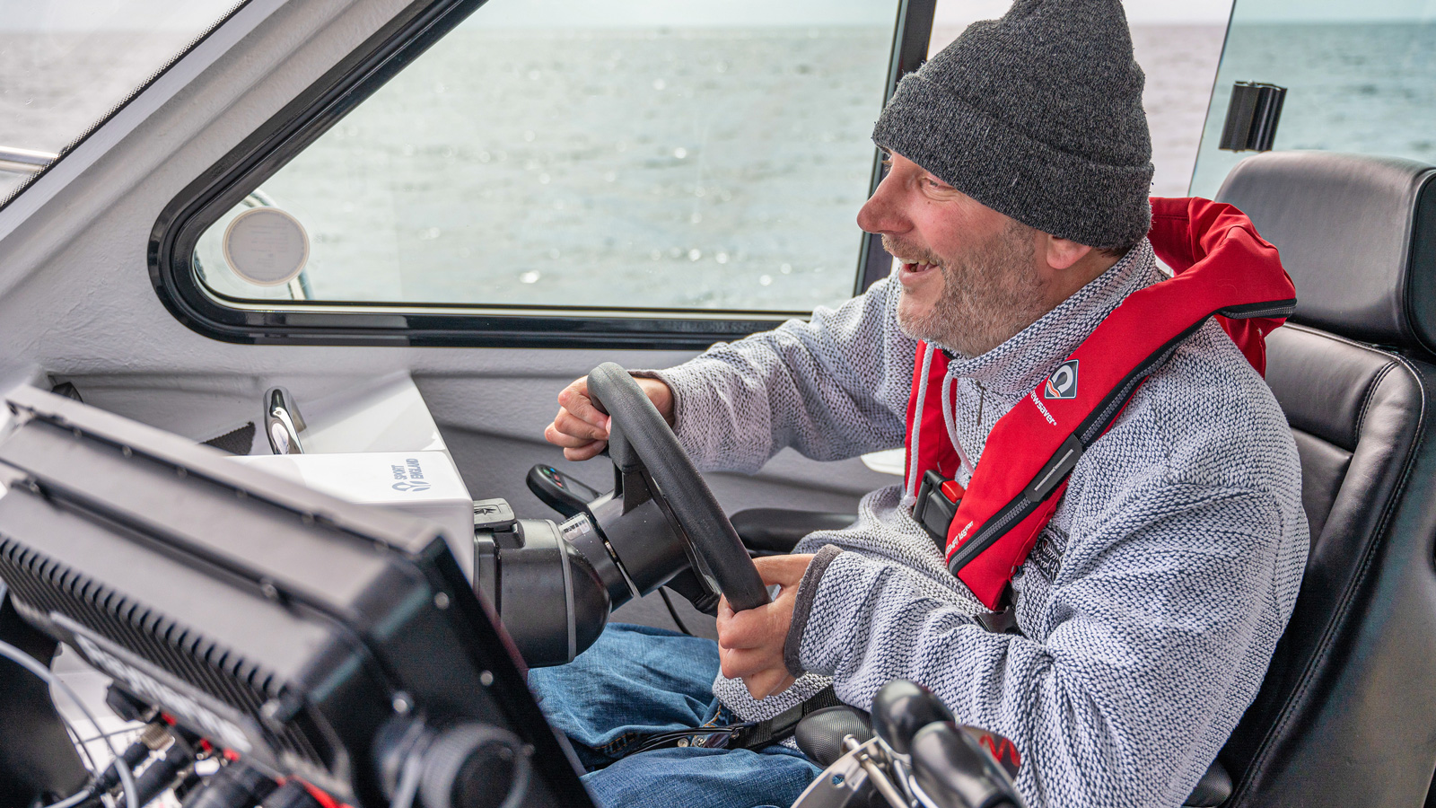 Steven Webb piloting the Wetwheels boat in Cornwall and having a great time in his electric wheelchair